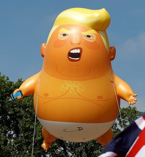 Demonstrators float a blimp portraying U.S. President Donald Trump, next to a Union Flag above Parliament Square, during the visit by Trump and First Lady Melania Trump in London
